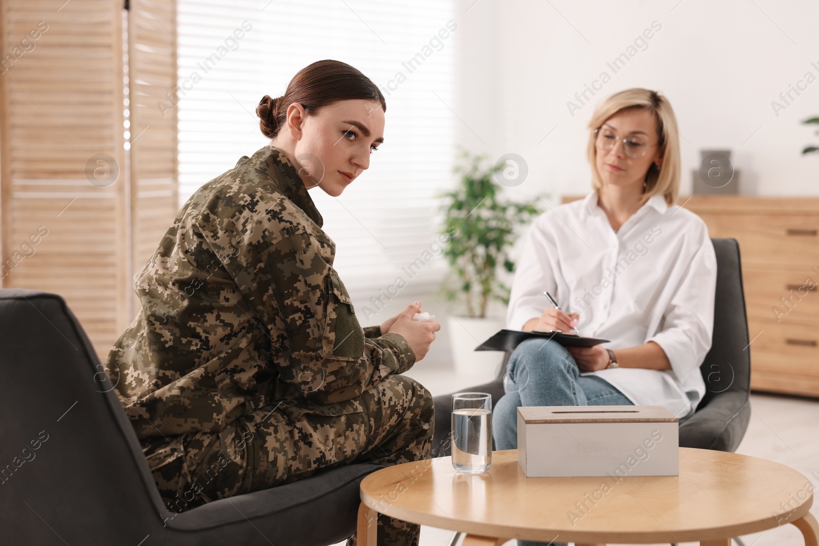 Photo of Psychotherapist working with military woman in office