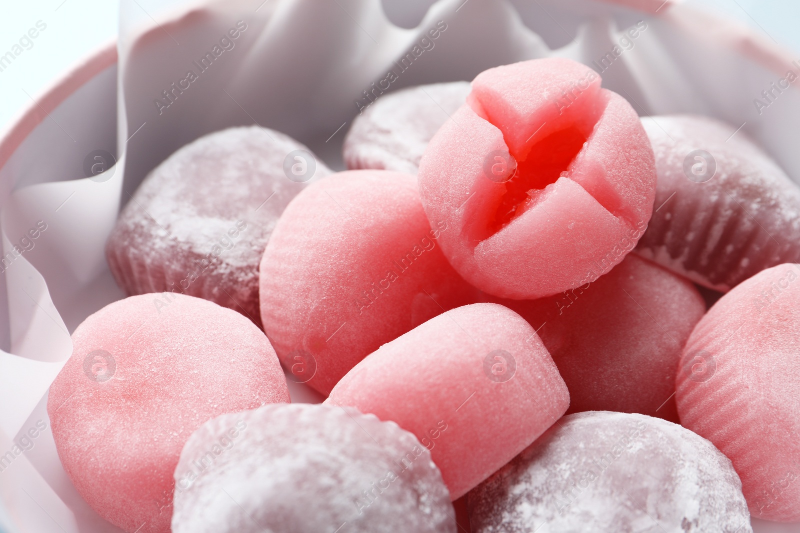 Photo of Many different delicious mochi in box, closeup. Traditional Japanese dessert