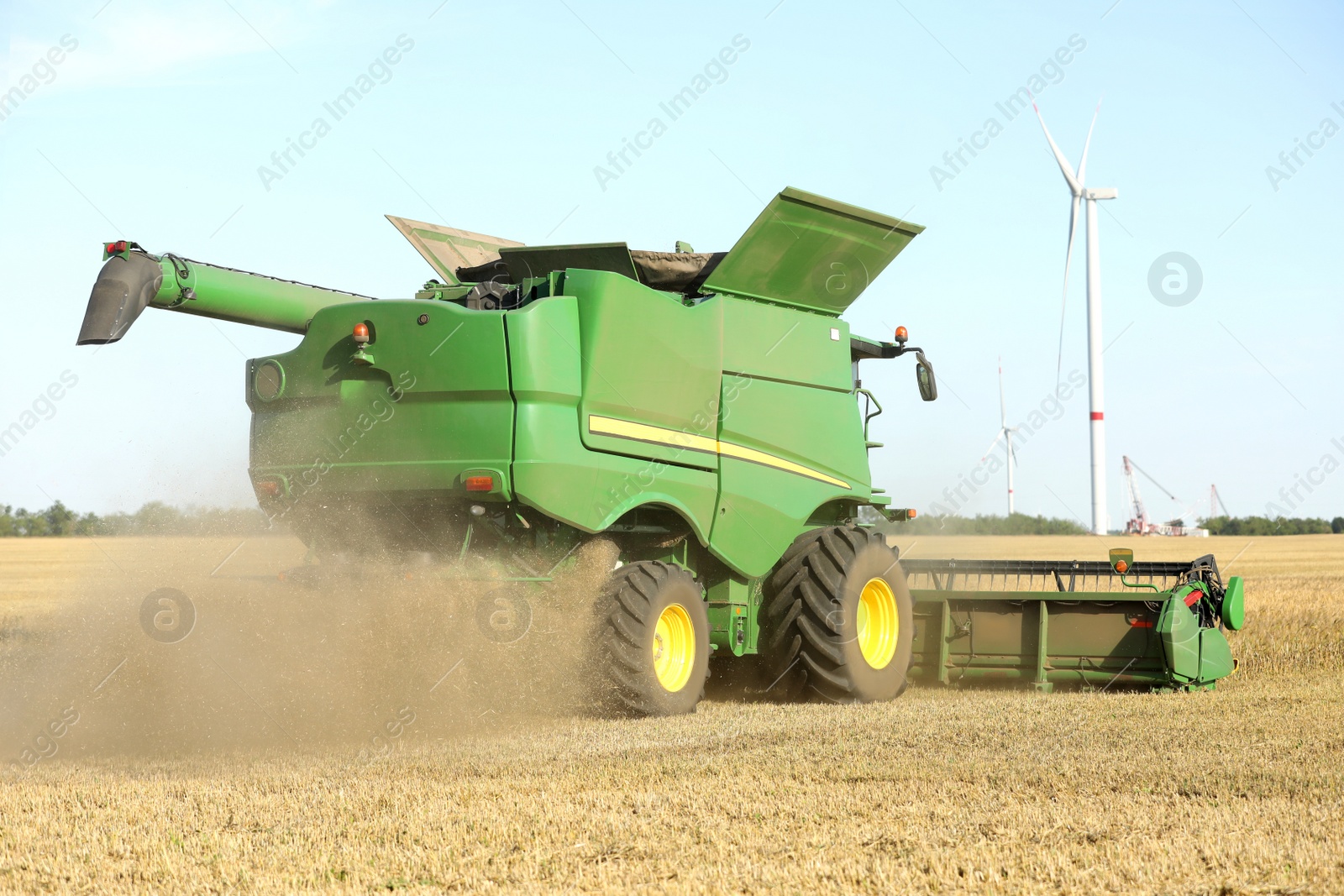 Photo of Modern combine harvester working in agricultural field