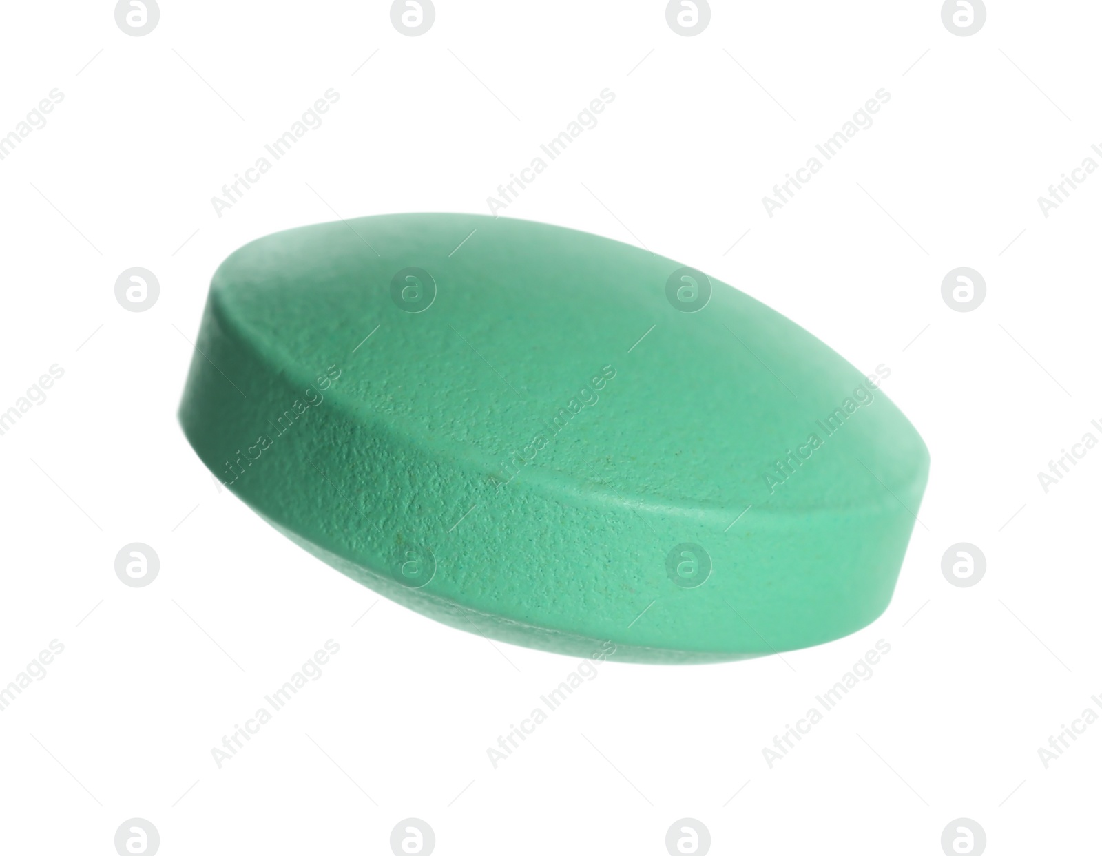 Photo of One green pill on white background. Medicinal treatment