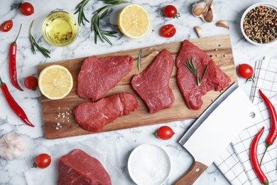 Photo of Fresh raw meat steaks and spices on white marble table, flat lay