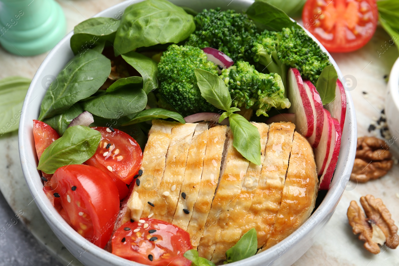 Photo of Healthy meal. Delicious chicken, vegetables and spinach in bowl on table, closeup