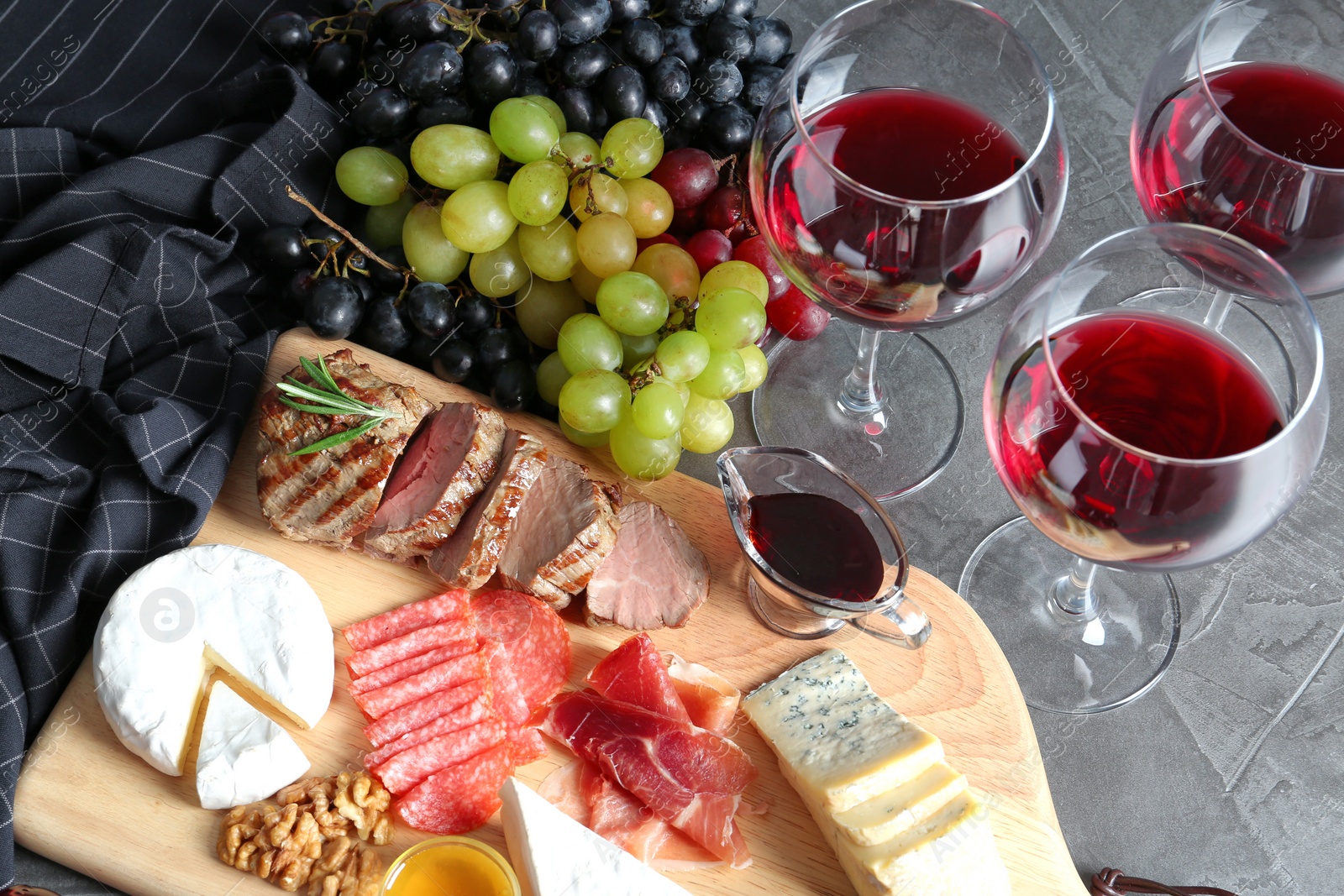 Photo of Composition with wine and snacks on grey table