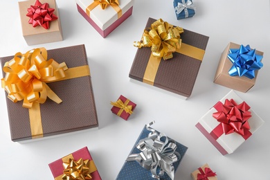 Photo of Beautiful gift boxes with bows on white background, top view