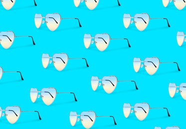 Image of Many stylish heart shaped sunglasses on turquoise background. Seamless pattern design