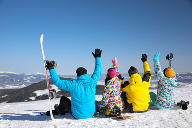 Group of friends with equipment at ski resort. Winter vacation