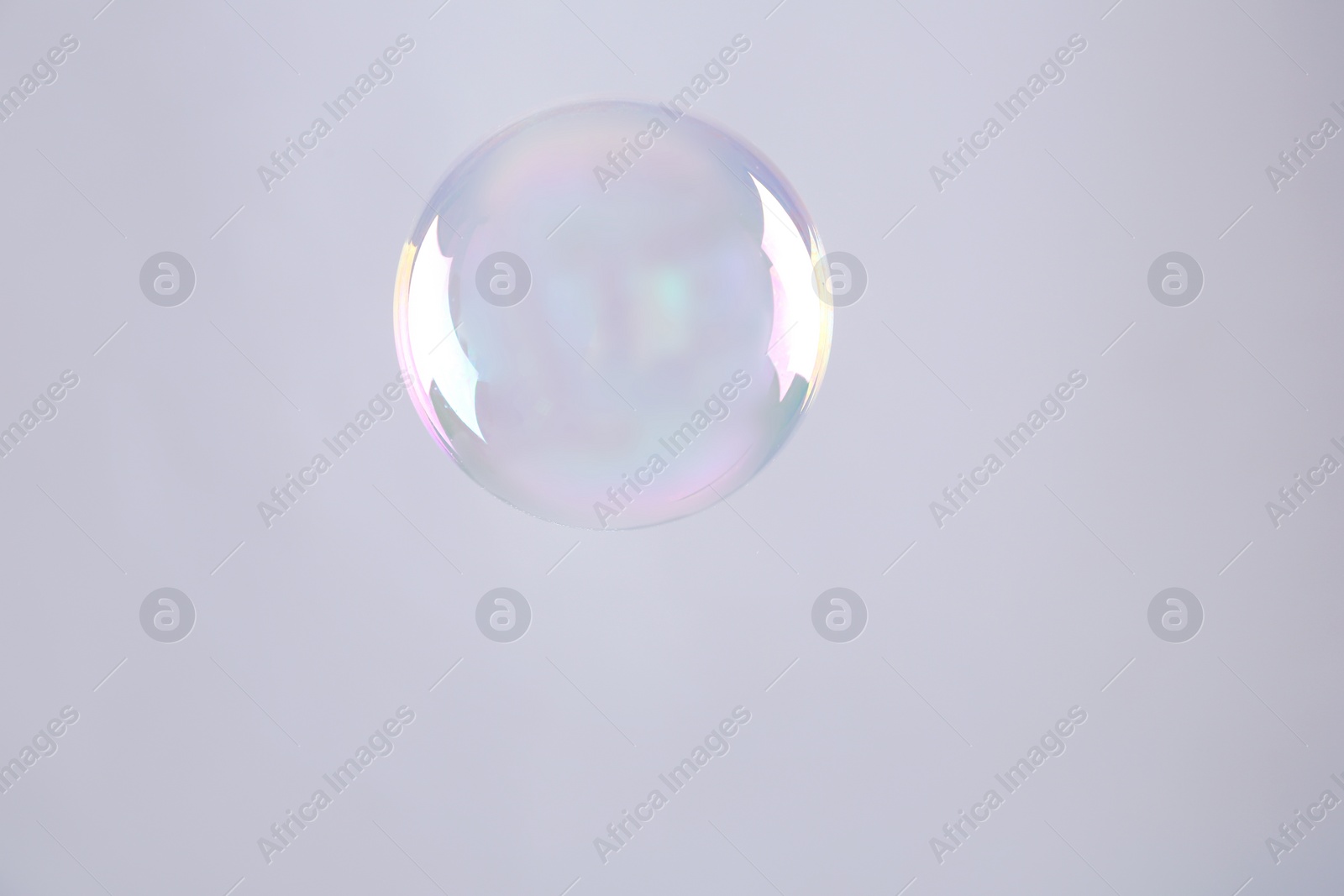 Photo of Beautiful translucent soap bubble on grey background