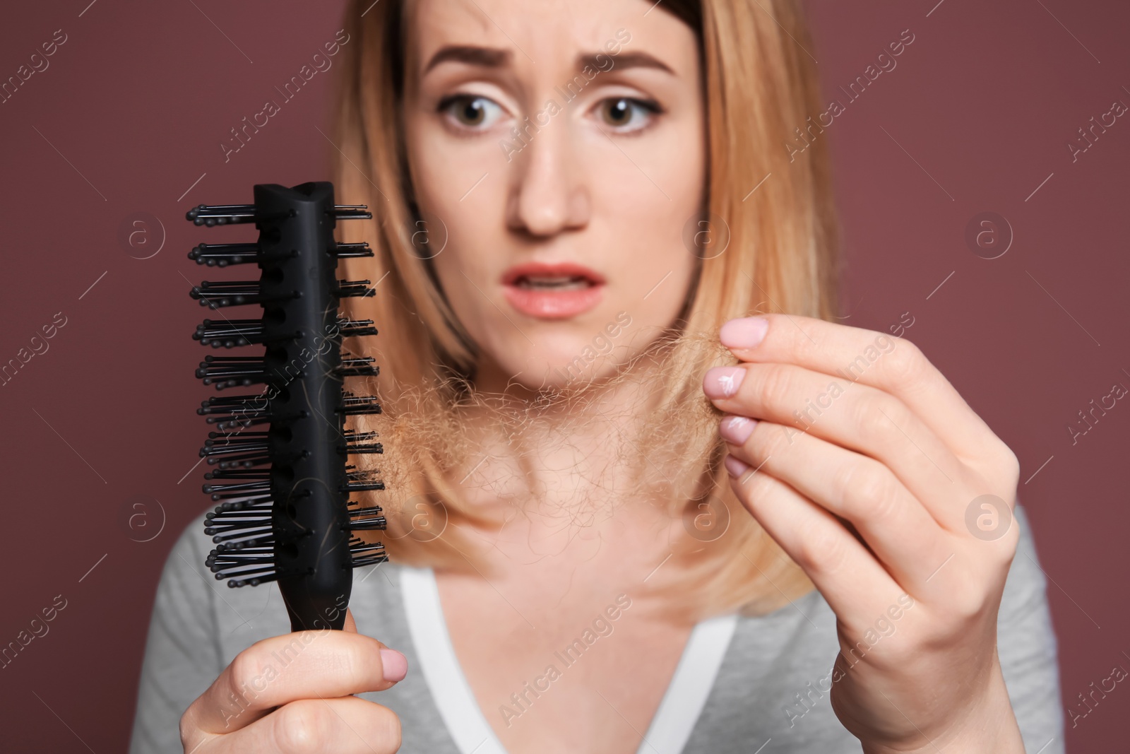 Photo of Young woman with hair loss problem on color background