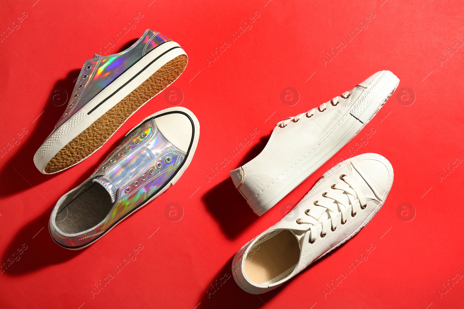 Photo of Flat lay composition with stylish sneakers on color background