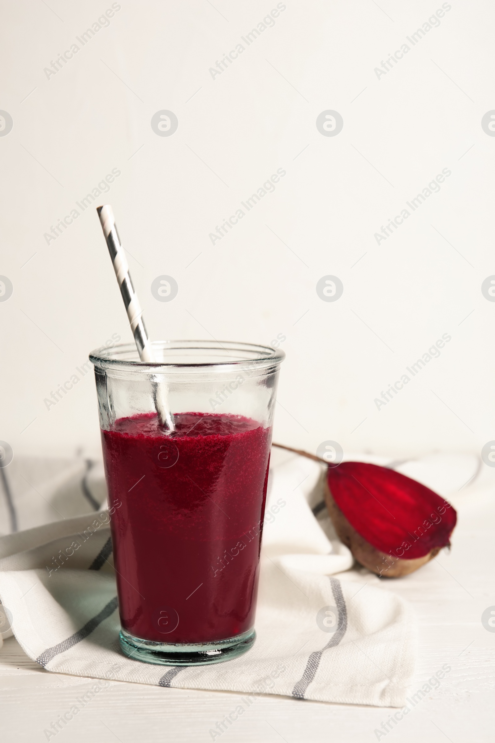 Photo of Glass of tasty beet smoothie on table