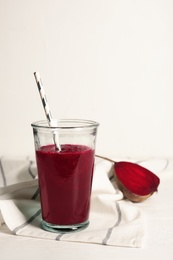 Glass of tasty beet smoothie on table