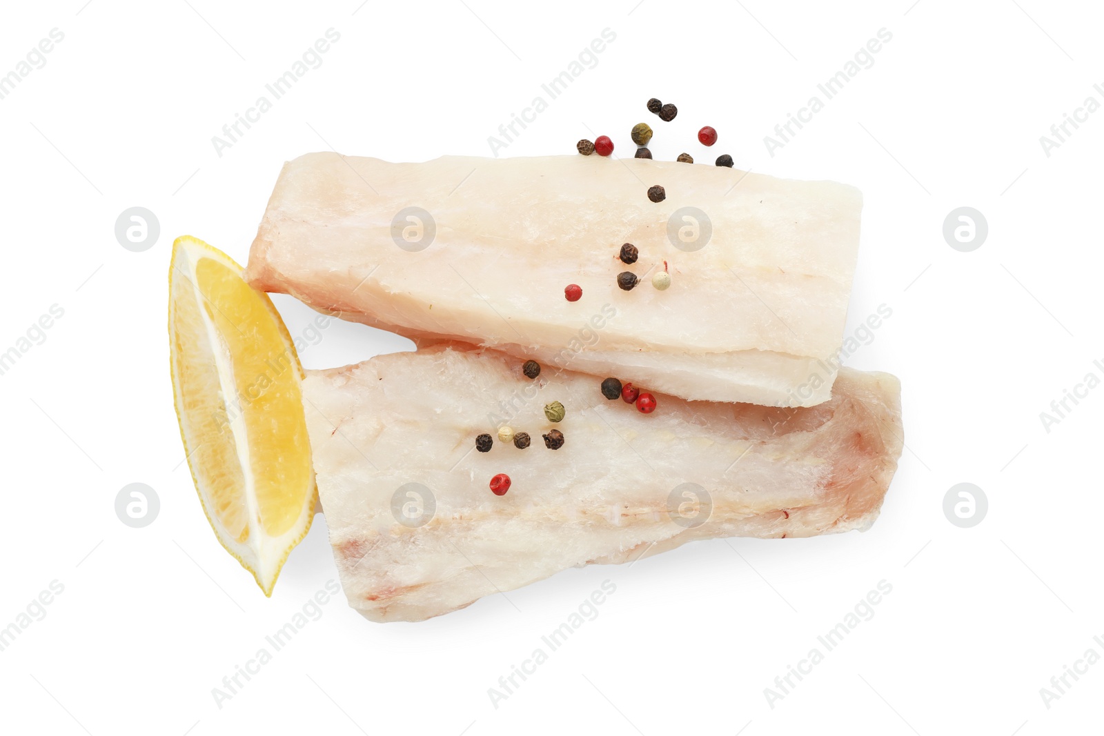 Photo of Fresh raw cod fillets with peppercorns and lemon isolated on white, top view