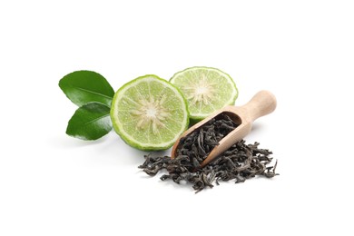 Photo of Dry bergamot tea leaves, wooden scoop and fresh fruit on white background