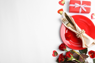 Beautiful table setting for romantic dinner on white background, flat lay. Valentine's day celebration