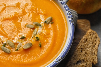 Photo of Bowl with tasty pumpkin soup, closeup view