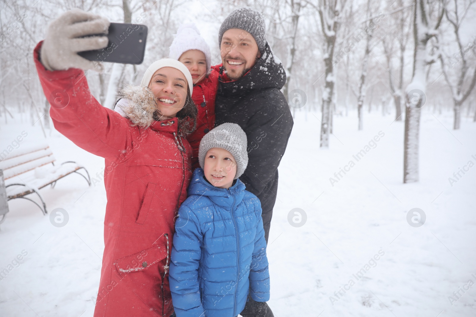 Photo of Happy family taking selfie outdoors on winter day. Christmas vacation