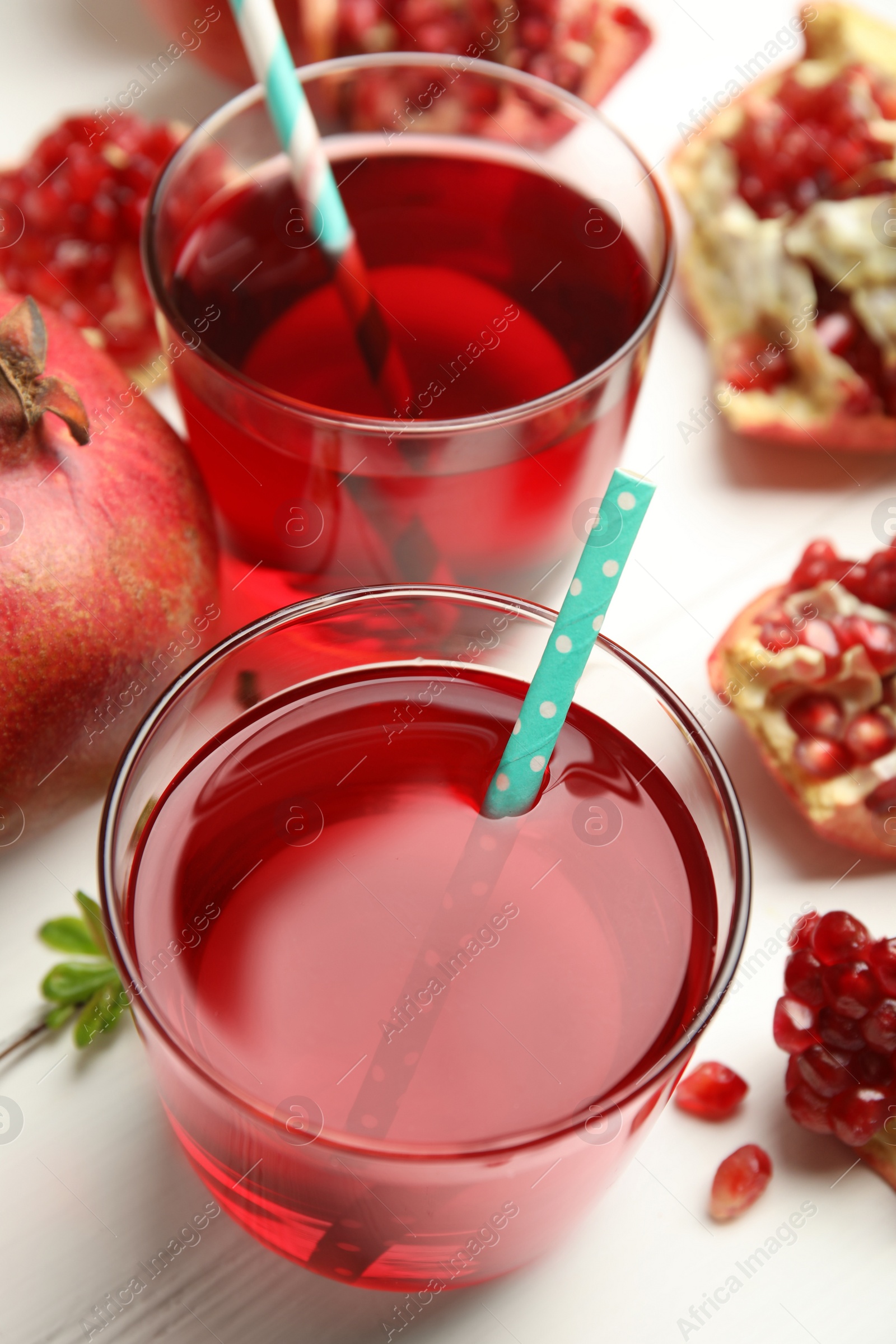 Photo of Pomegranate juice and fresh fruits on white table