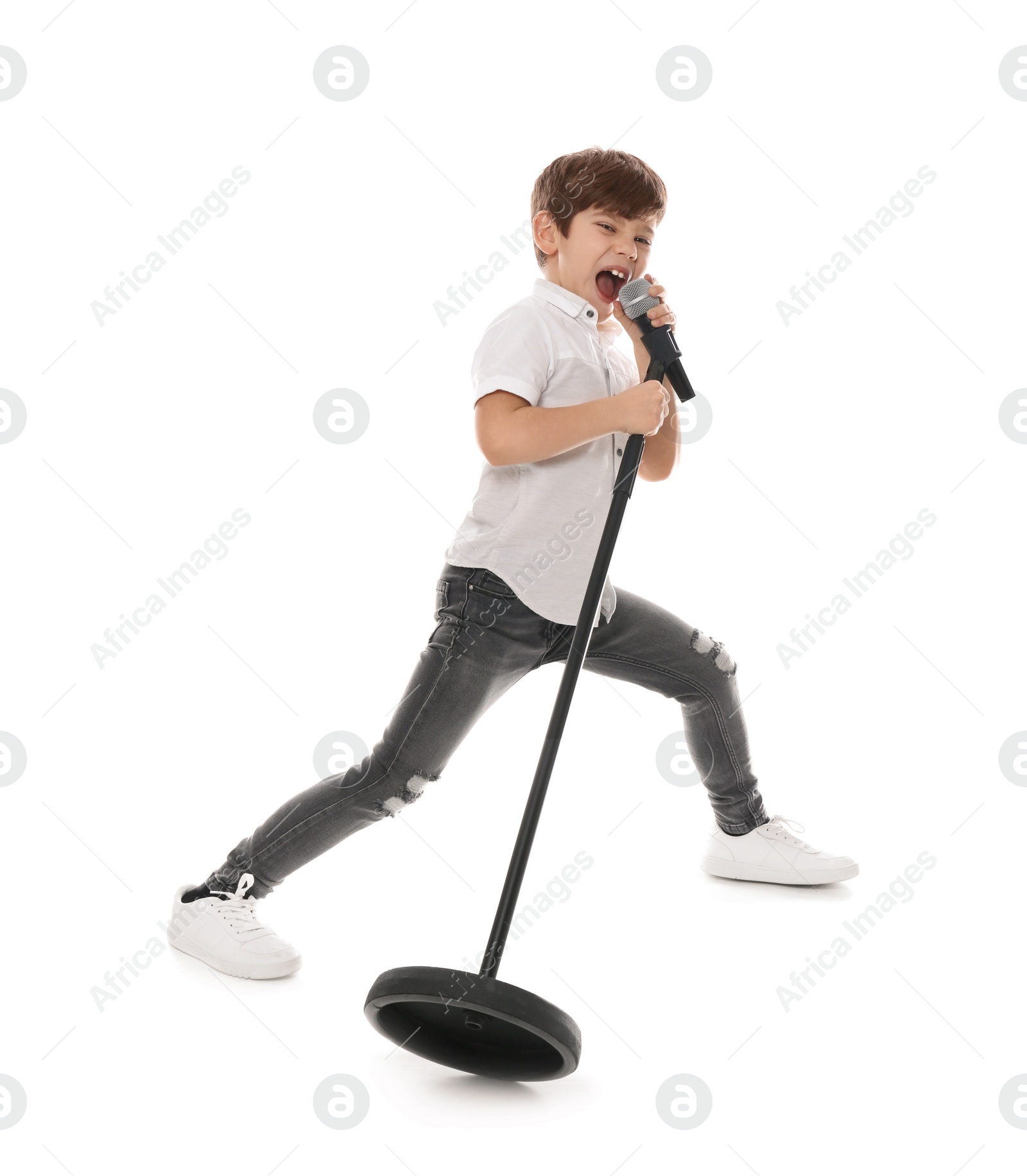 Photo of Cute little boy singing into microphone on white background