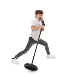 Cute little boy singing into microphone on white background