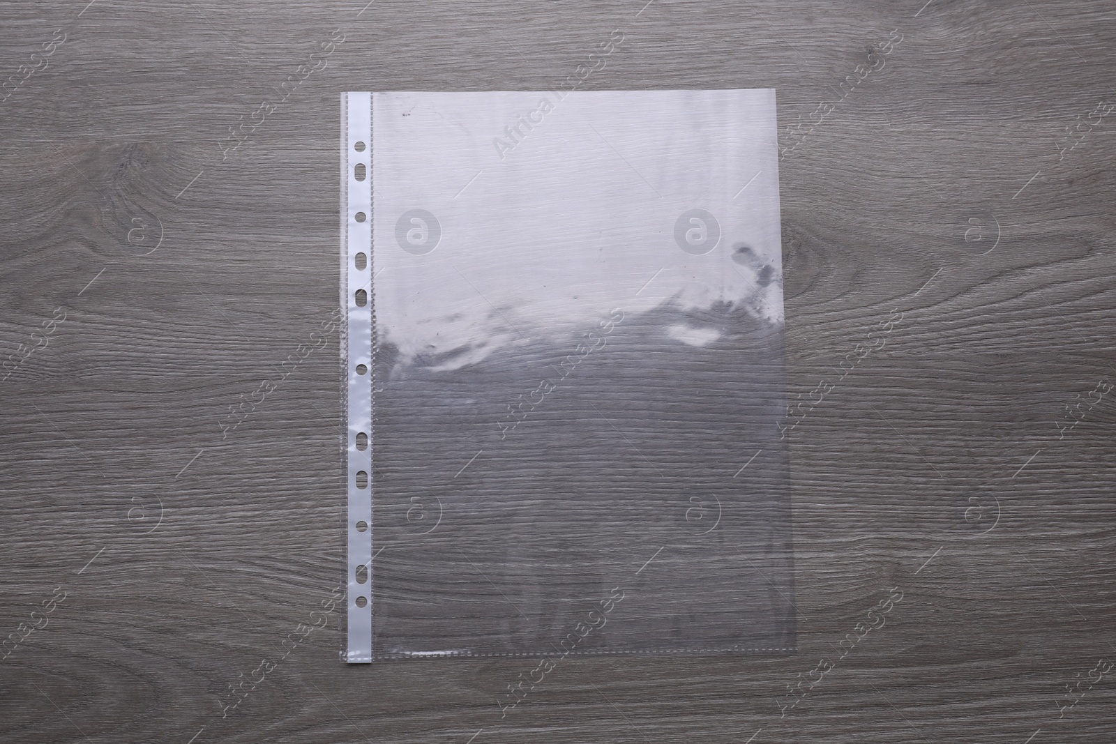 Photo of Punched pocket on wooden table, top view