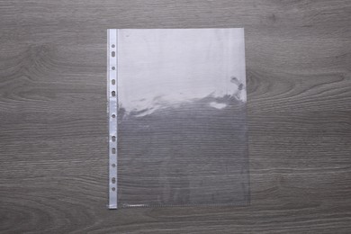 Photo of Punched pocket on wooden table, top view