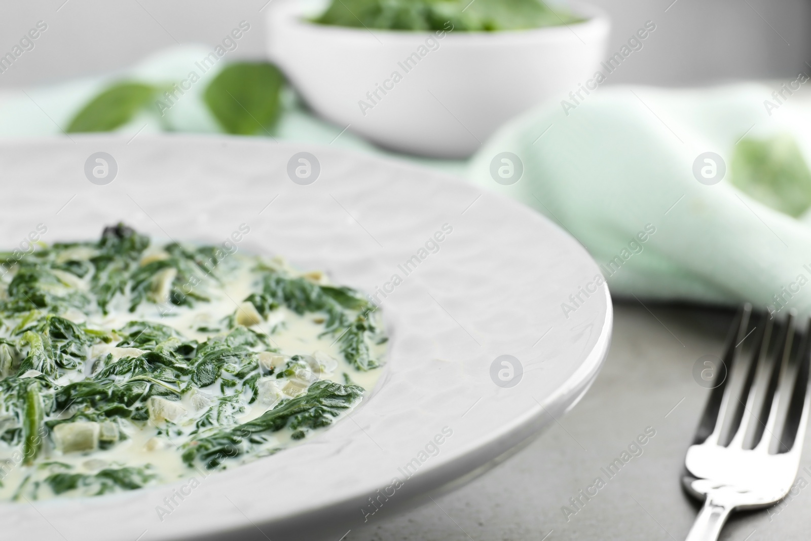 Photo of Tasty spinach dip on grey table, closeup