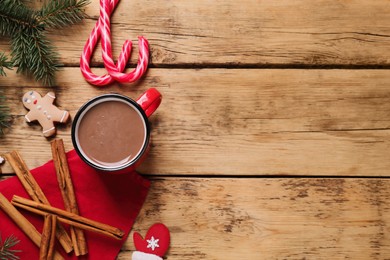 Photo of Flat lay composition with delicious hot chocolate and gingerbread cookies on wooden table, space for text