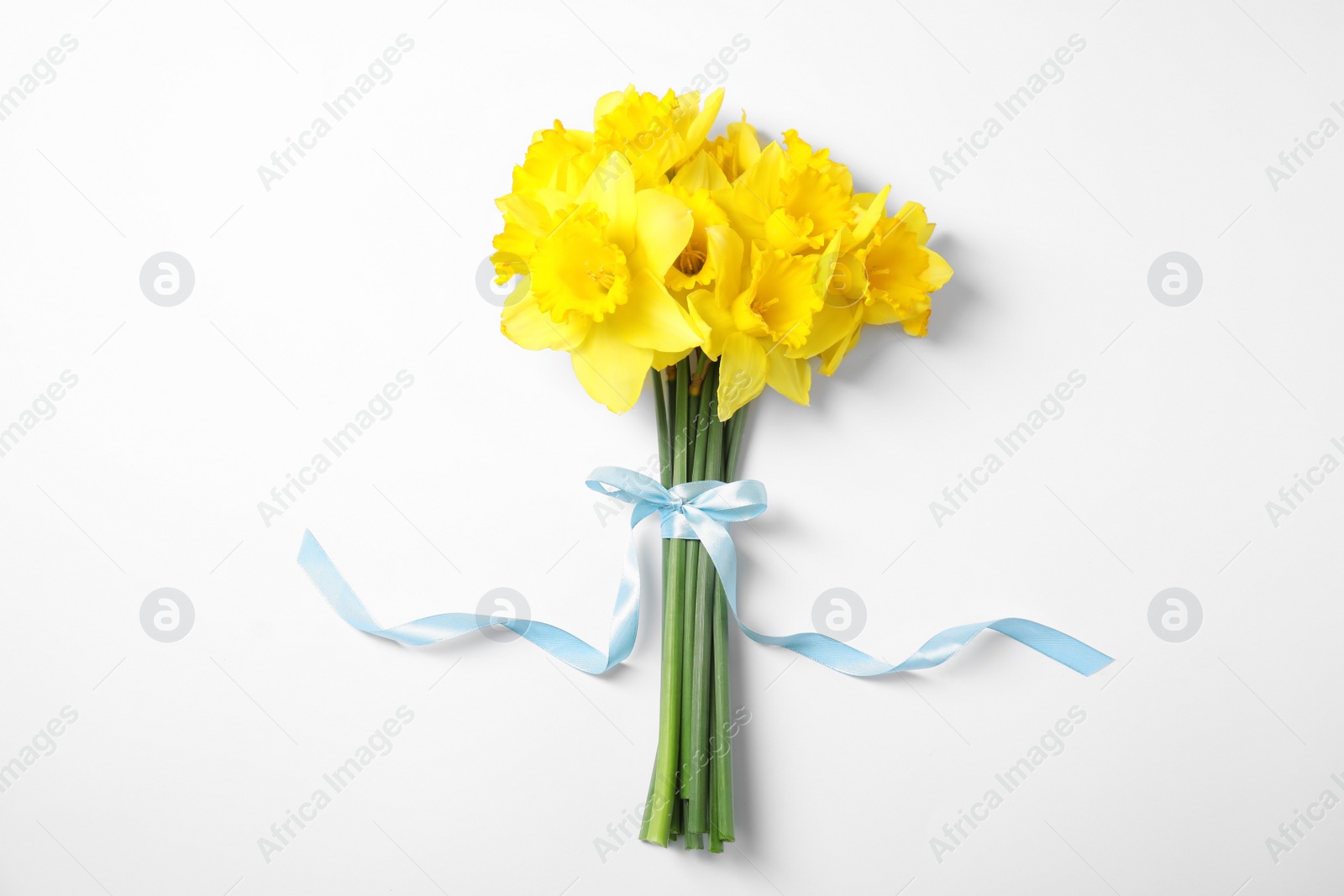 Photo of Bouquet of daffodils on white background, top view. Fresh spring flowers