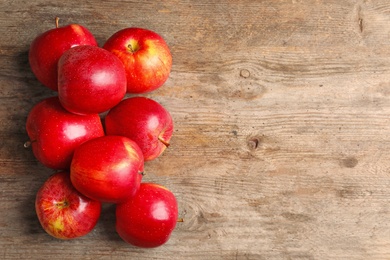 Ripe red apples on wooden background