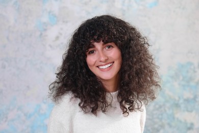 Photo of Portrait of happy young woman in stylish sweater on color background