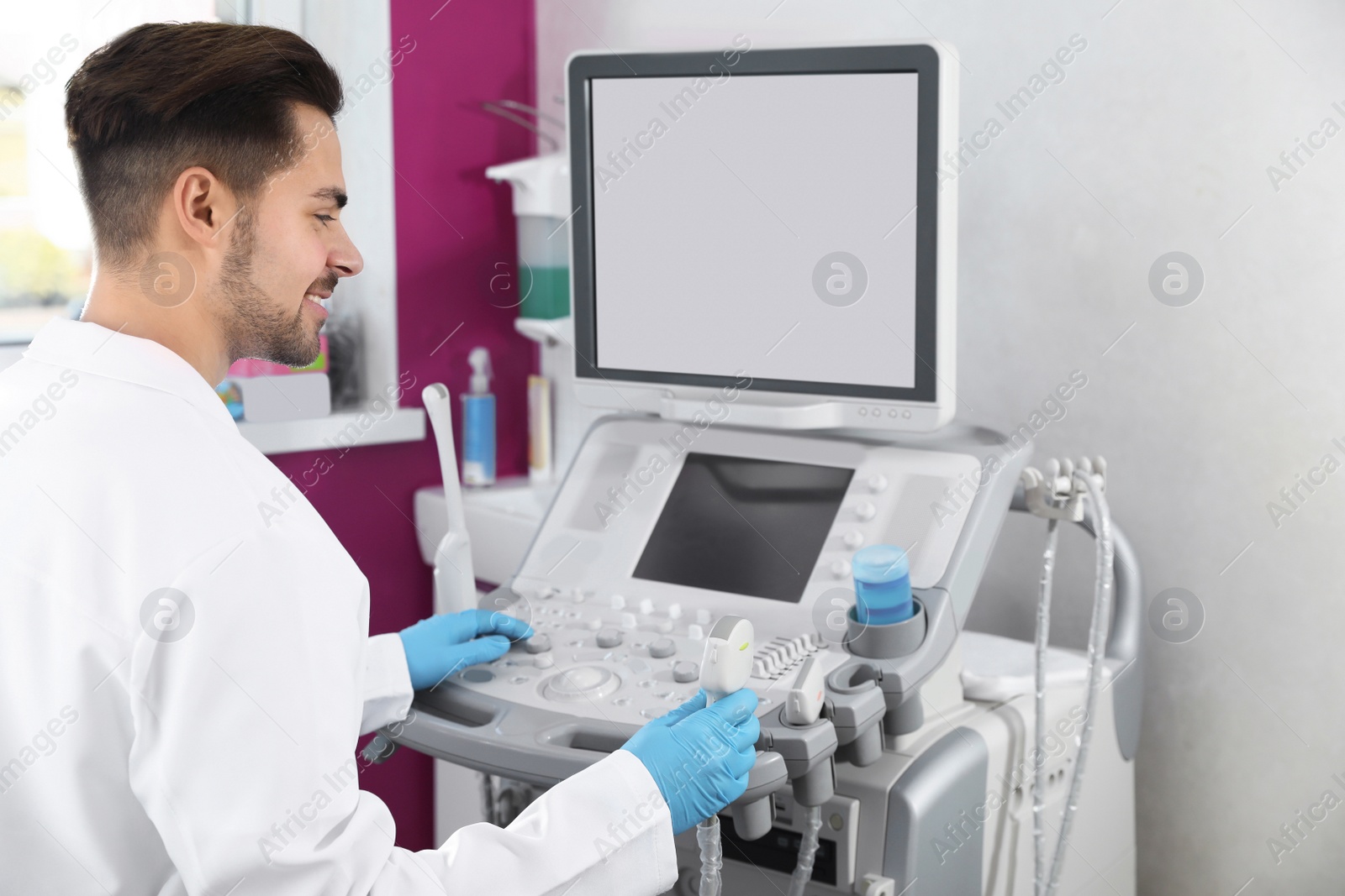 Photo of Sonographer using modern ultrasound machine in clinic