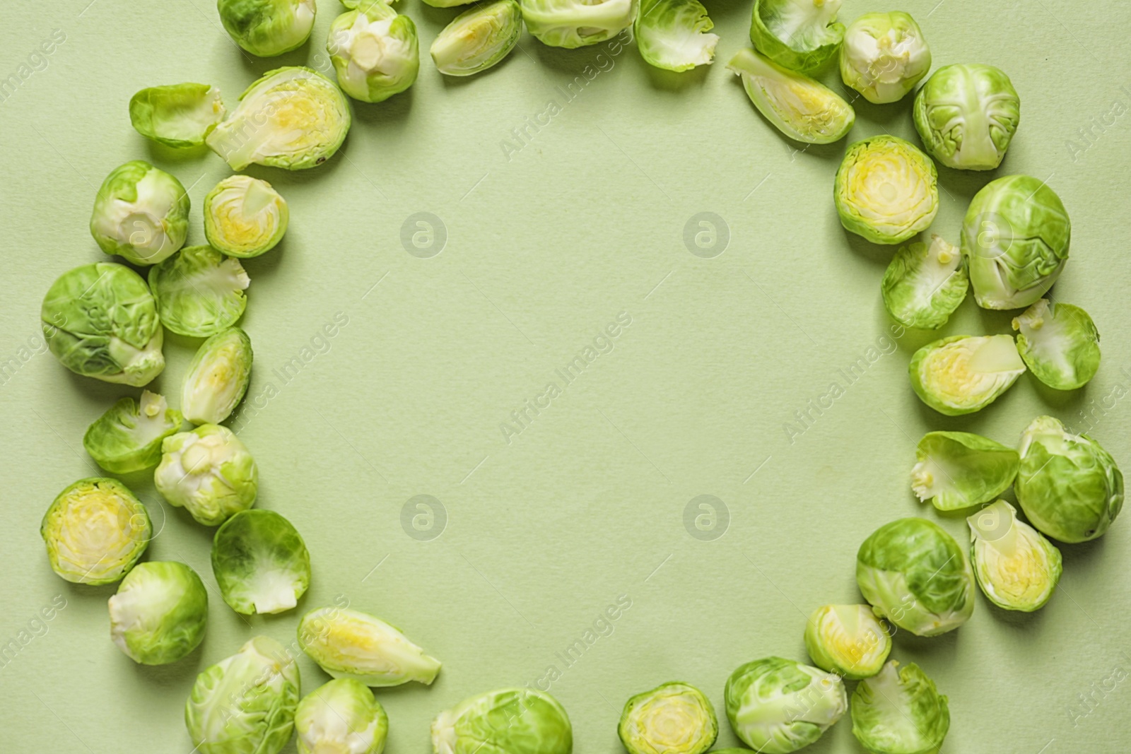 Photo of Frame made with Brussels sprouts on color background, top view. Space for text