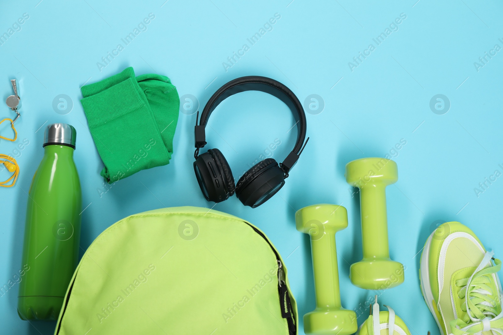 Photo of Different sports equipment on light blue background, flat lay