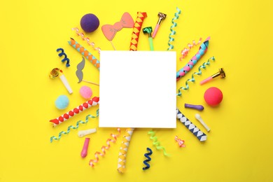 Photo of Flat lay composition with carnival items and blank card on yellow background. Space for text
