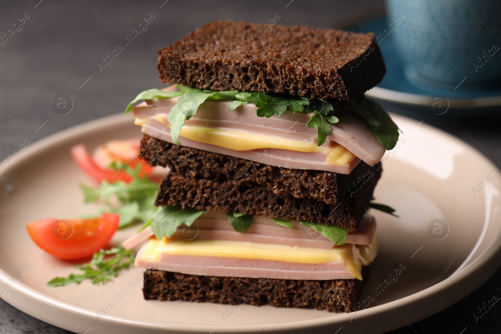 Photo of Delicious sandwiches with boiled sausage, cheese and arugula on table, closeup