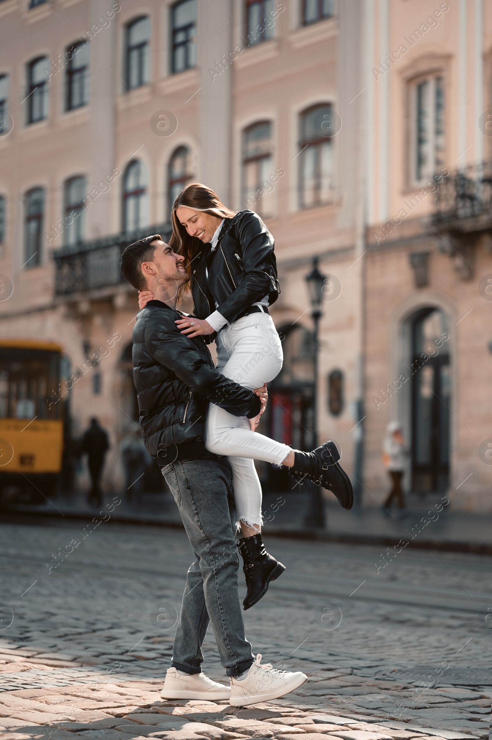 Photo of Lovely young couple having fun together on city street. Romantic date