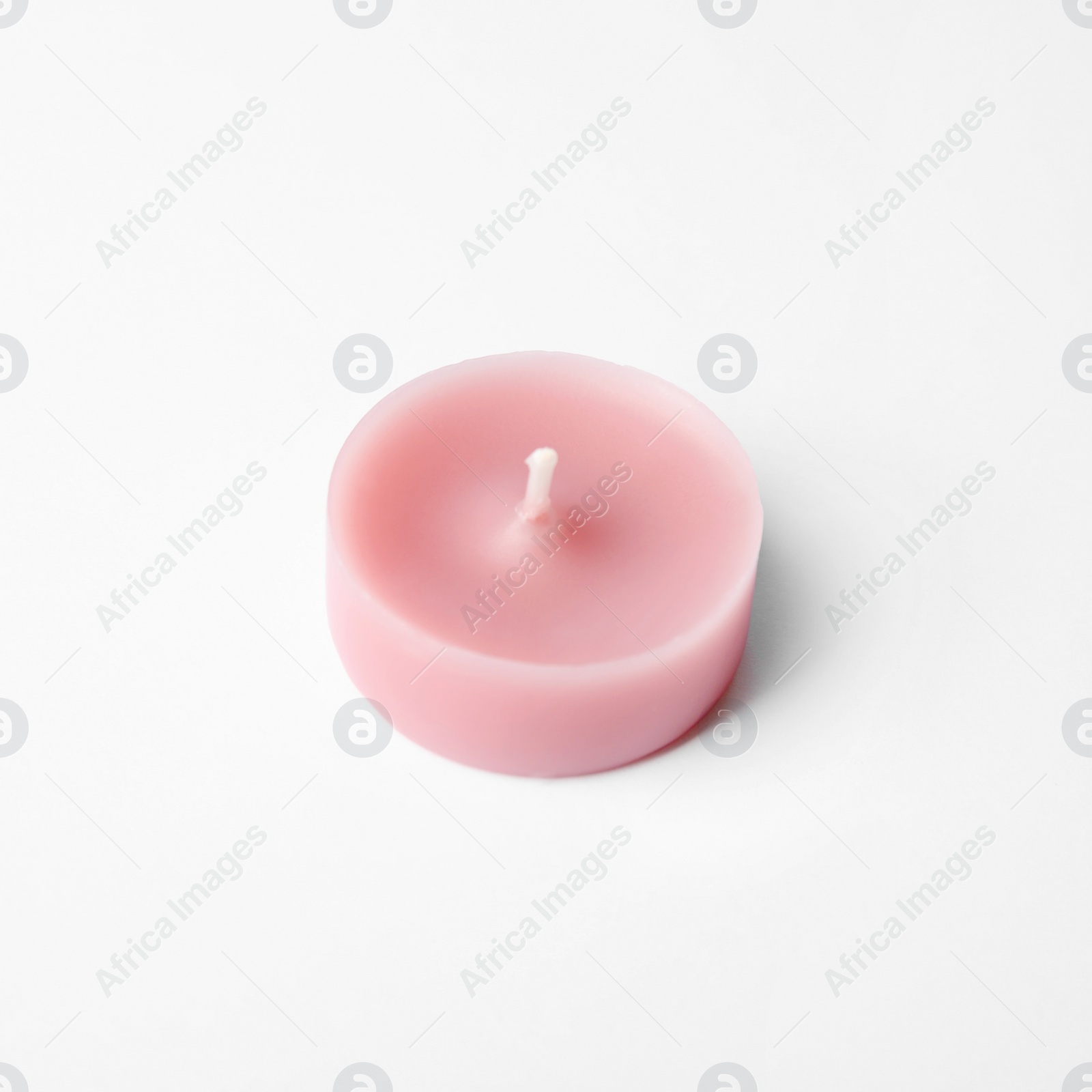 Photo of Pink wax decorative candle isolated on white