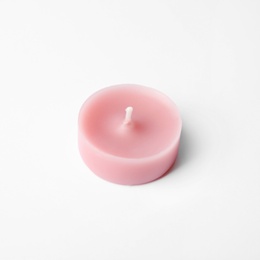 Photo of Pink wax decorative candle isolated on white