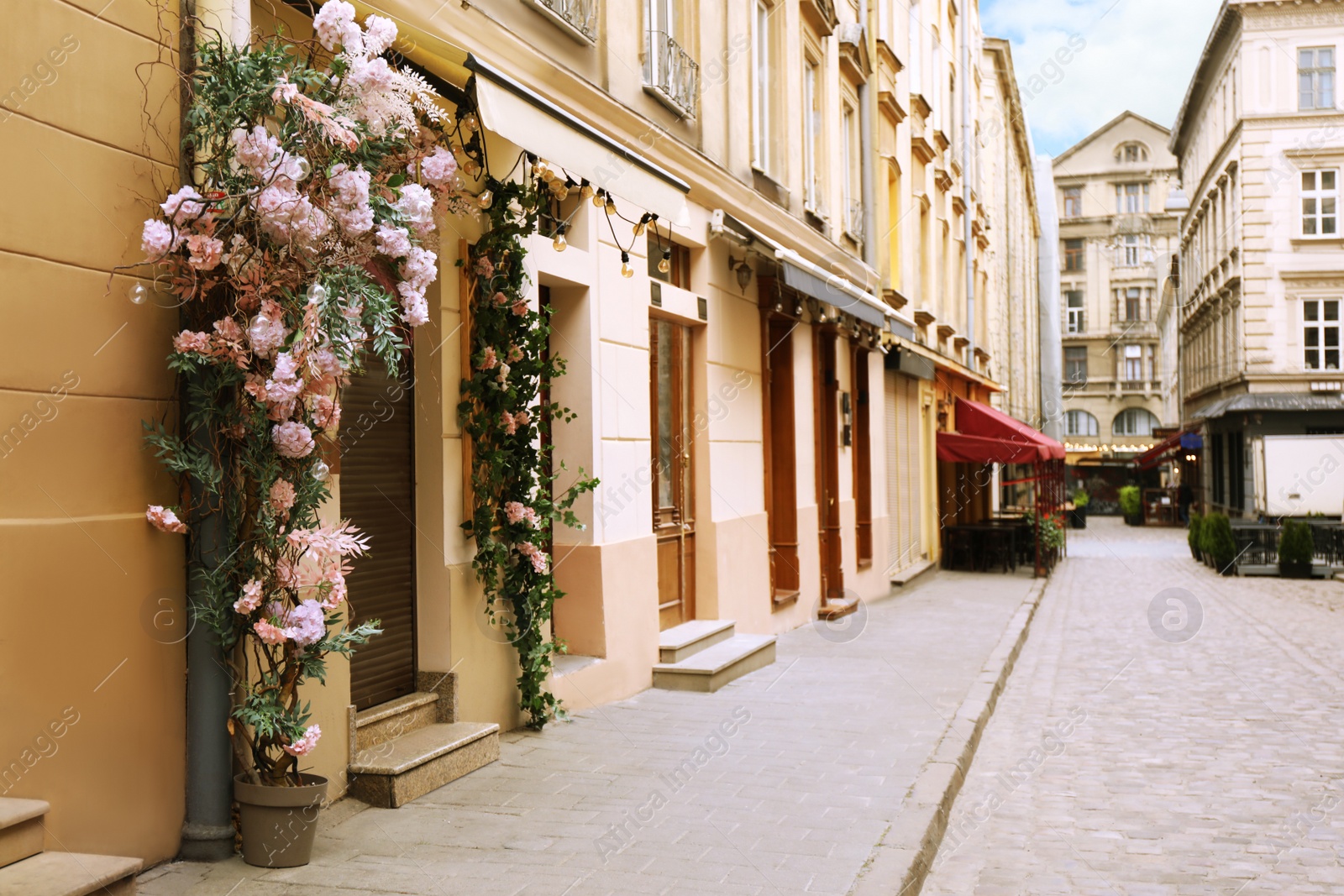 Photo of Modern building decorated with beautiful flowers on city street