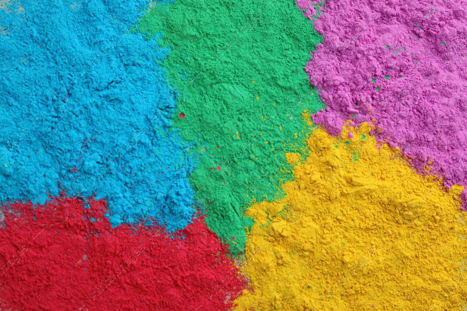 Photo of Colorful powder dyes as background, top view. Holi festival