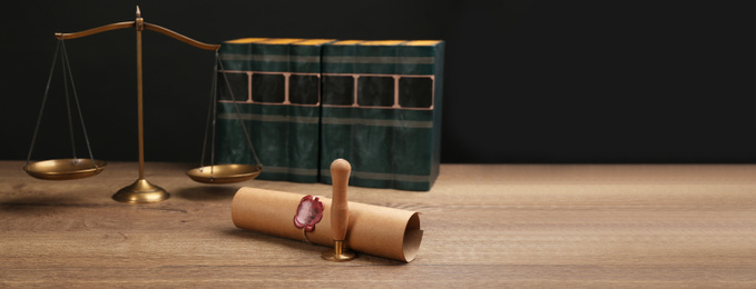 Notary's public pen, sealed document and scales on wooden table against black background, space for text. Banner design