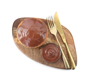 Tasty pancakes with chocolate paste and cutlery isolated on white, top view