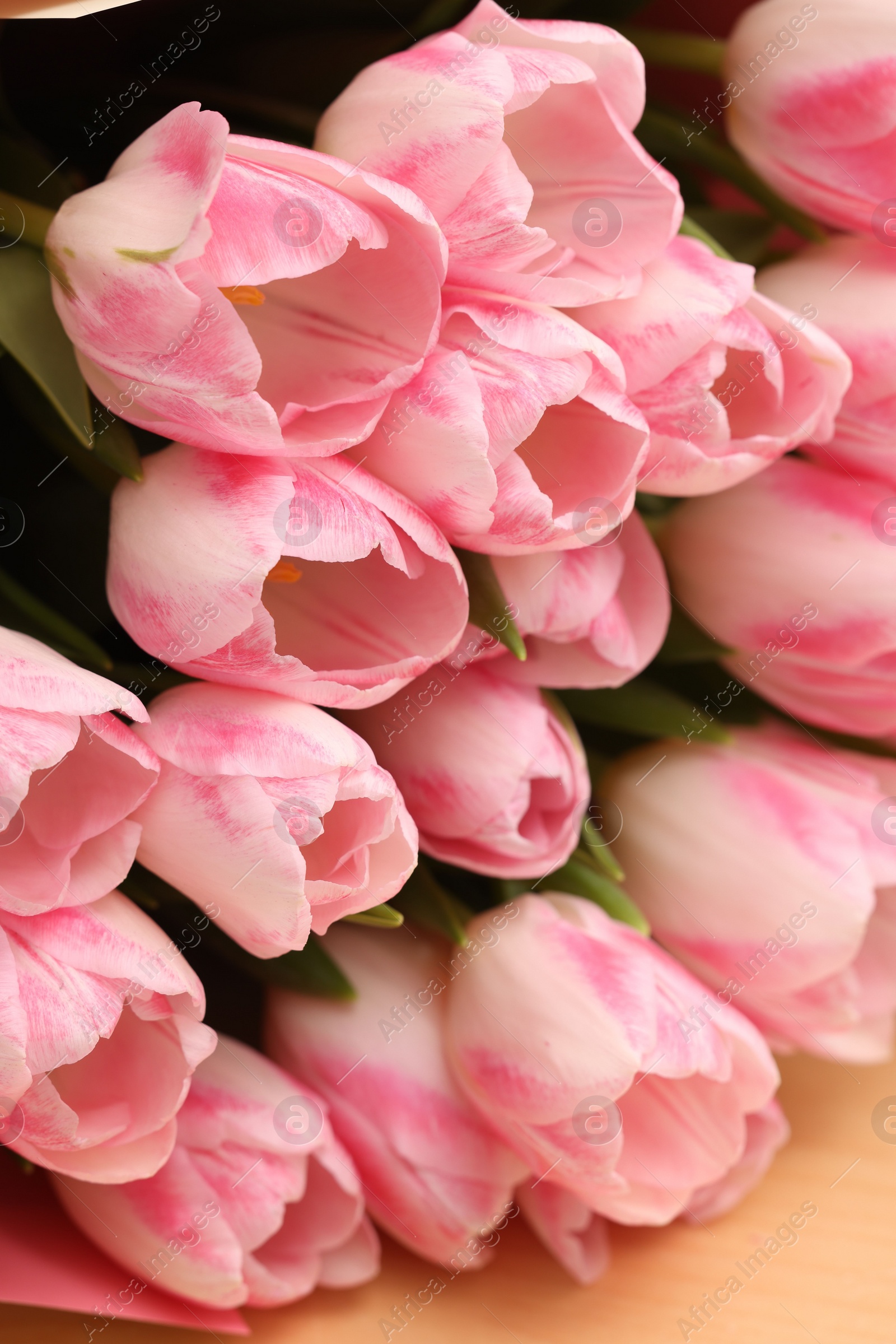 Photo of Beautiful bouquet of fresh pink tulips on table, closeup