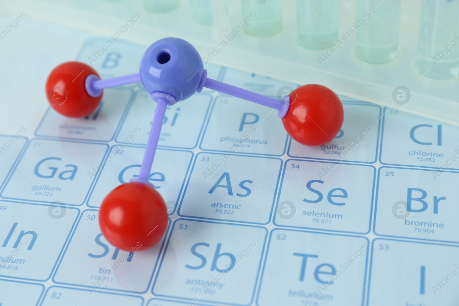 Photo of Molecular model and test tubes on periodic table