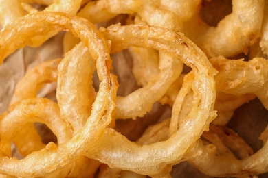 Photo of Homemade delicious golden breaded and deep fried crispy onion rings, closeup