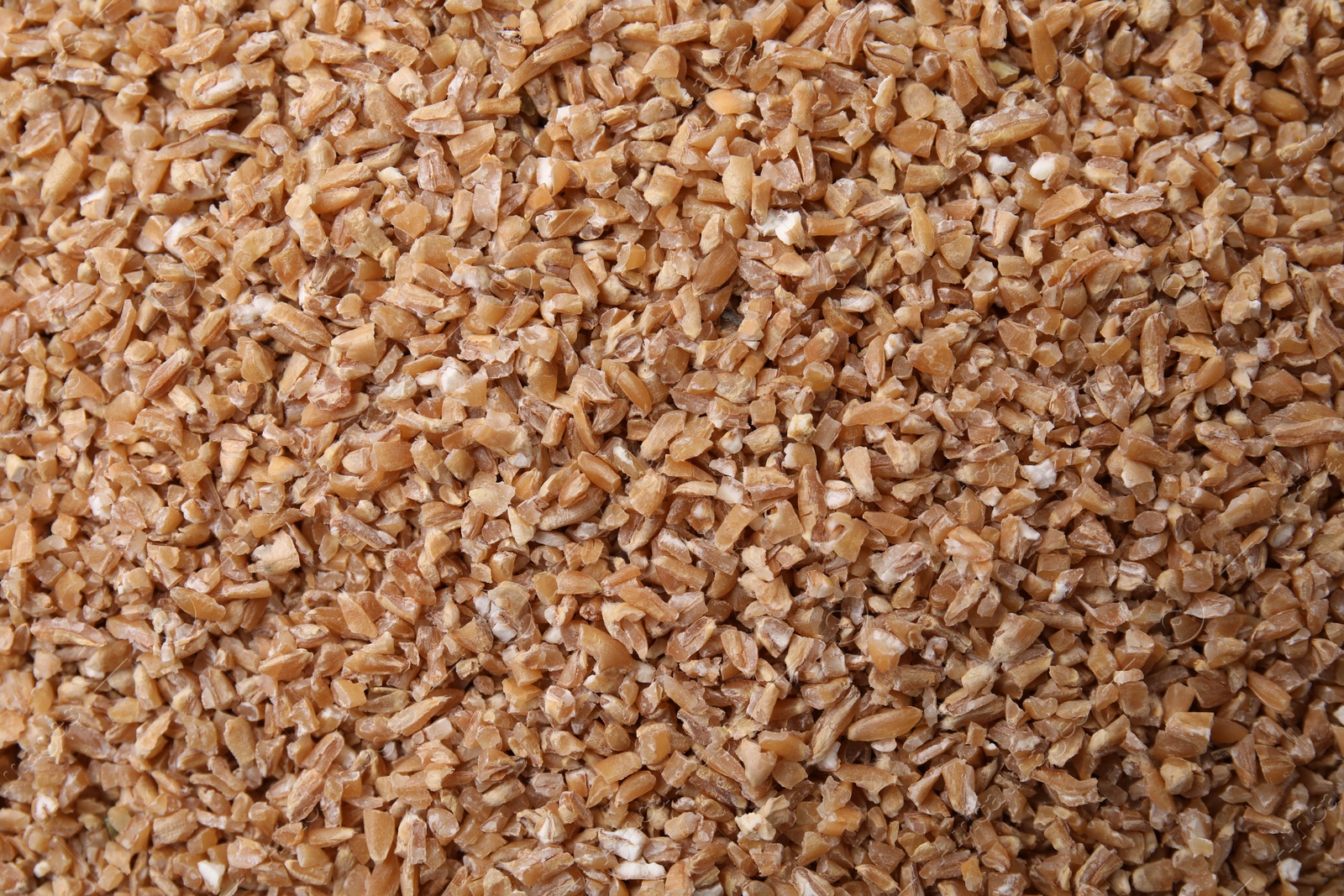 Photo of Dry wheat groats as background, top view
