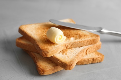 Toasted bread with butter curl on table