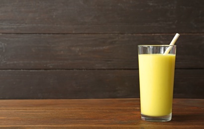 Glass with delicious detox smoothie on table