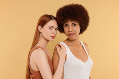 Portrait of beautiful young women on beige background