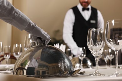 People setting table during professional butler courses in restaurant, closeup